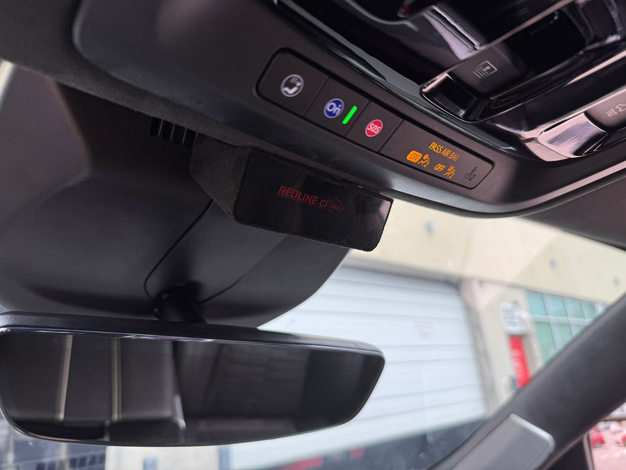 Car interior with a digital display showing various icons and text