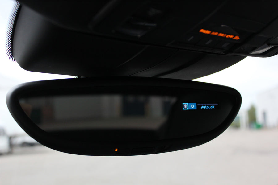 Close up shot of cars review mirror with an AutoLok notification